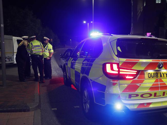 Police officers are seen at a police cordon in central Reading, west of London, following a stabbing incident at Forbury Gardens park. Picture: Adrian Dennis/AFP