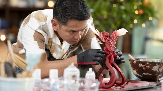 Arvin puts the finishing touches on his final bake: a rising Phoenix cake. Picture: Stuart Bryce