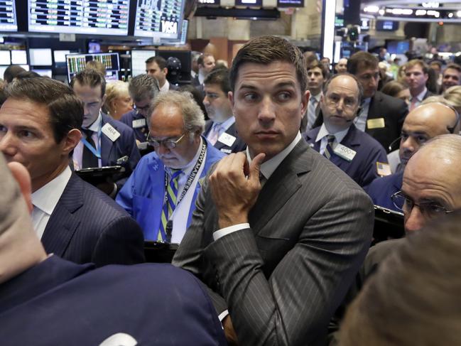 NYSE Group President Tom Farley, center, stands among traders on the trading floor, Wednesday, Aug. 5, 2015. U.S. stocks are rising in early trading, shaking off a three-day slump, as the latest round of company earnings news brought several positive surprises. (AP Photo/Richard Drew)