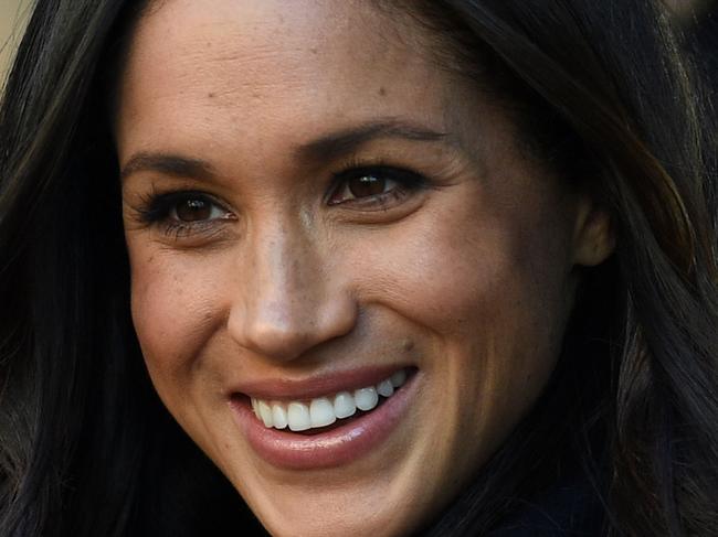 Britain's Prince Harry's fiancee US actress Meghan Markle greets wellwishers on a walkabout as they arrive for an engagement at Nottingham Contemporary in Nottingham, central England, on December 1, 2017 which is hosting a Terrence Higgins Trust World AIDS Day charity fair. Prince Harry and Meghan Markle visited Nottingham in their first set of engagements together since announcing their engagement. / AFP PHOTO / Oli SCARFF