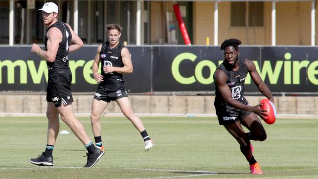 Port Adelaide’s Tom Jonas, left, Jackson Mead and Martin Fredrick train at Alberton Oval. Picture: Kelly Barnes