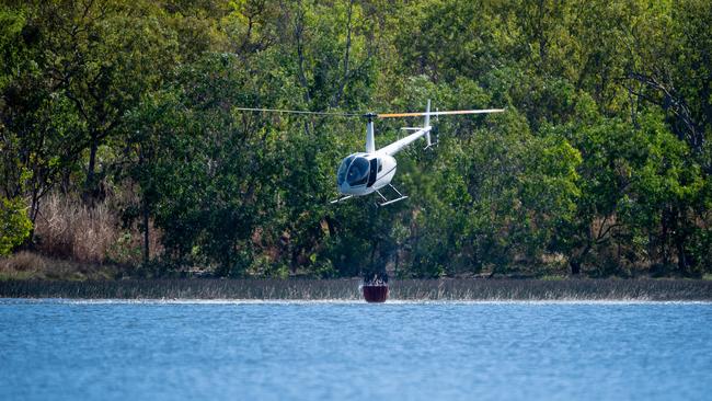 Darwin's rural areas have seen a series of bushfires during the NT's worst fire rating days of the past two years. More extreme fire days are expected later in the week. A bushfire threatens homes and properties in the idyllic Lake Bennett region. Multiple helicopters and volunteer fire fighting units battled the blaze for two days. A helicopter gets water to attack the fires directly from Lake Bennett. Picture: Che Chorley