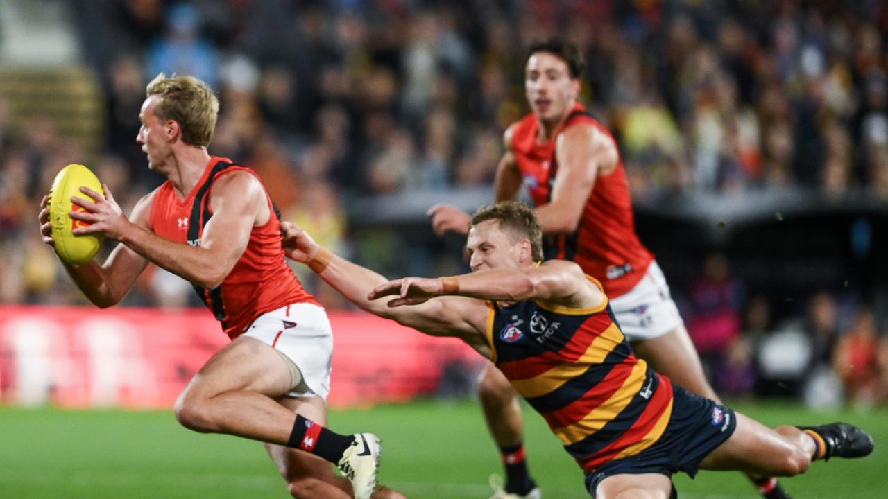 ADELAIDE, AUSTRALIA – APRIL 19: Darcy Parish of the Bombers breaks away from Jordan Dawson of the Crows during the round six AFL match between Adelaide Crows and Essendon Bombers at Adelaide Oval, on April 19, 2024, in Adelaide, Australia. (Photo by Mark Brake/Getty Images)