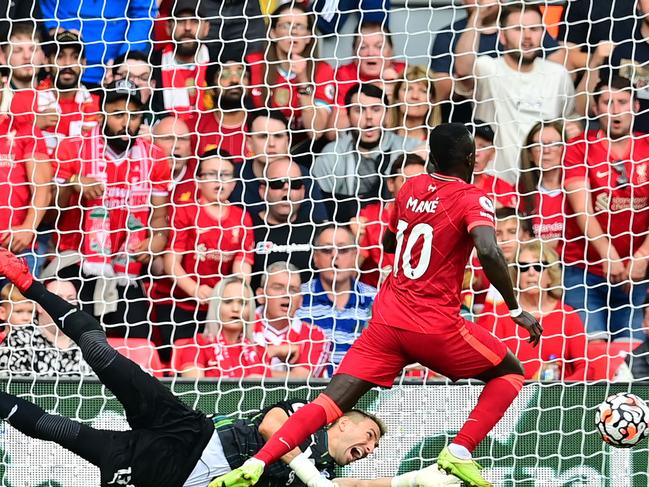 Liverpool's Senegalese striker Sadio Mane scores the opening goal past Crystal Palace's Spanish goalkeeper Vicente Guaita during the English Premier League football match between Liverpool and Crystal Palace at Anfield in Liverpool, north west England on September 18, 2021. (Photo by Paul ELLIS / AFP) / RESTRICTED TO EDITORIAL USE. No use with unauthorized audio, video, data, fixture lists, club/league logos or 'live' services. Online in-match use limited to 120 images. An additional 40 images may be used in extra time. No video emulation. Social media in-match use limited to 120 images. An additional 40 images may be used in extra time. No use in betting publications, games or single club/league/player publications. /