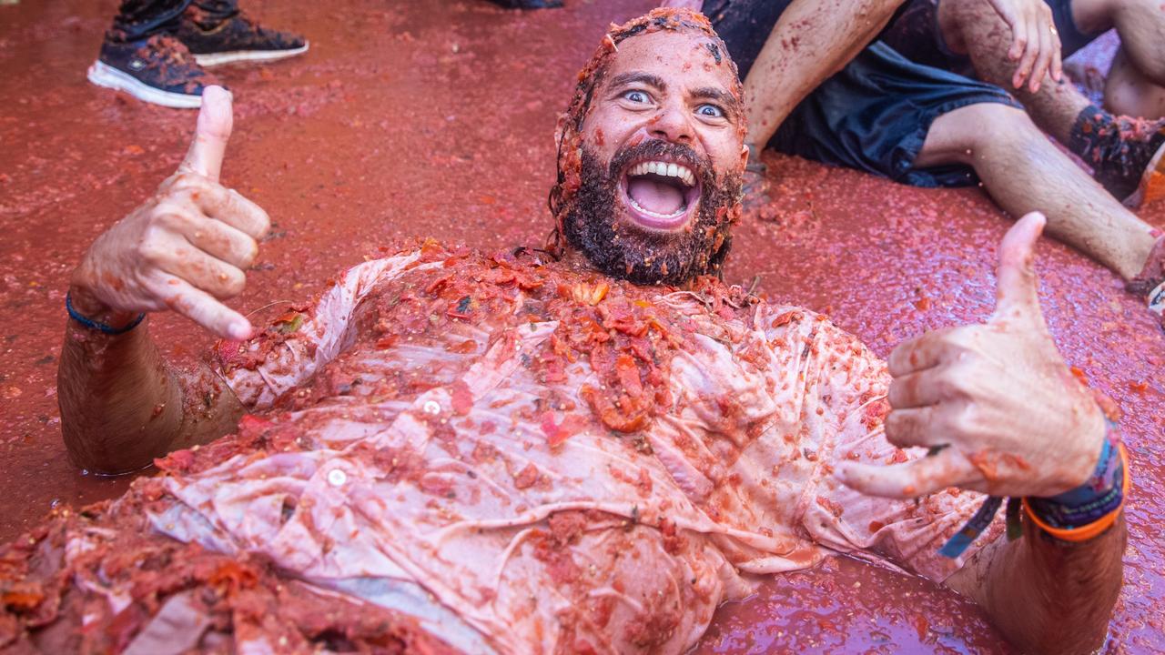 Don’t try this at home: 15,000 revellers threw ripe tomatoes and rolled around in a sea of pulp at the revived Tomatina festival in Buñol Spain, dubbed the world's largest food fight. Picture: Zowy Voeten/Getty Images