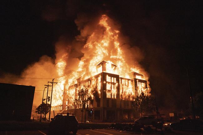 A multi-story affordable housing complex under construction near the Third Precinct, burns in Minneapolis. Picture: AP