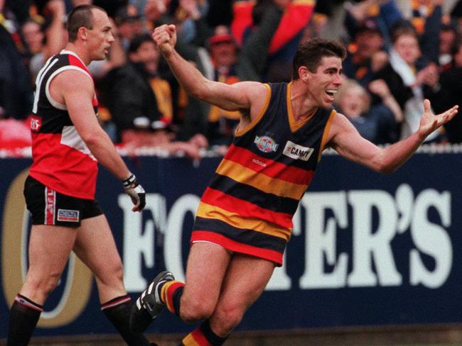 Adelaide Crows’ Darren Jarman celebrates as St Kilda’s Jamie Shanahan looks on.