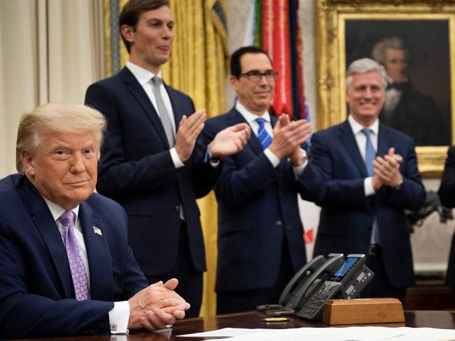 (L-R, rear) Senior Advisor Jared Kushner, US Secretary of the Treasury Steven Mnuchin and National Security Advisor Robert O'Brien clap for US President Donald Trump (L) after he announced an agreement between UAE and Israel to normalization diplomatic ties, the White House August 13, 2020, in Washington, DC. - Trump on Thursday made the surprise announcement of a peace agreement between Israel and the United Arab Emirates. The normalization of relations between the UAE and Israel is a "HUGE breakthrough" Trump tweeted, calling it a "Historic Peace Agreement between our two GREAT friends." (Photo by Brendan Smialowski / AFP)