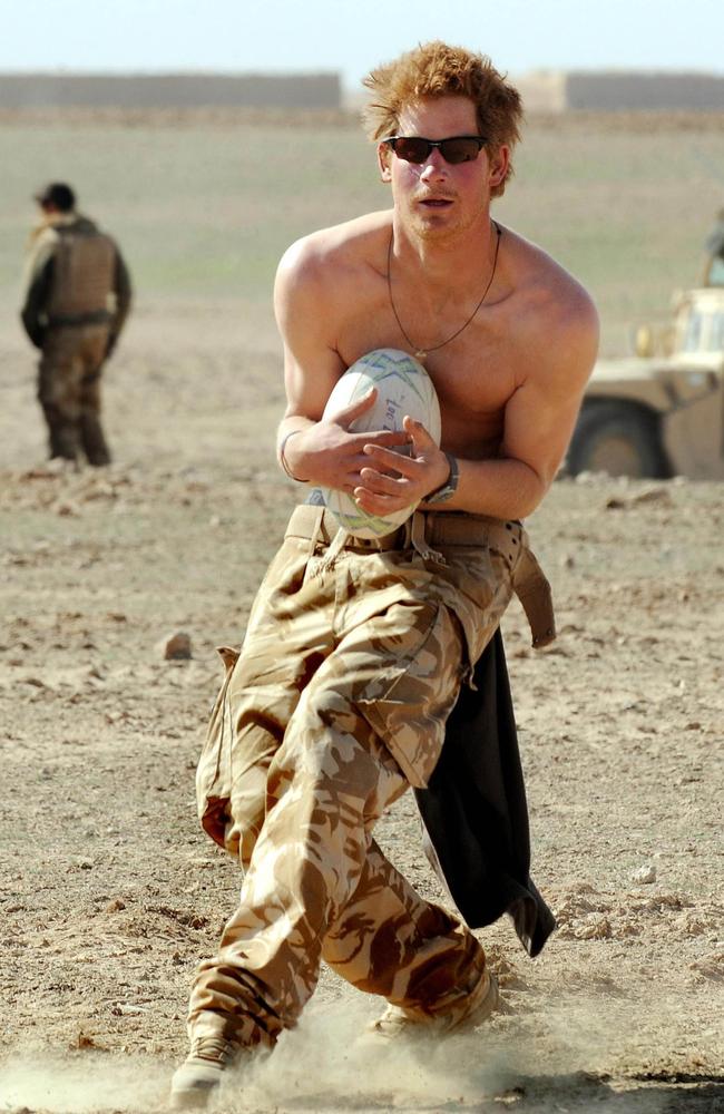 Prince Harry practices his rugby skills during a break in the desert on January 2, 2008 in Helmand Province, Afghanistan. Picture: John Stillwell