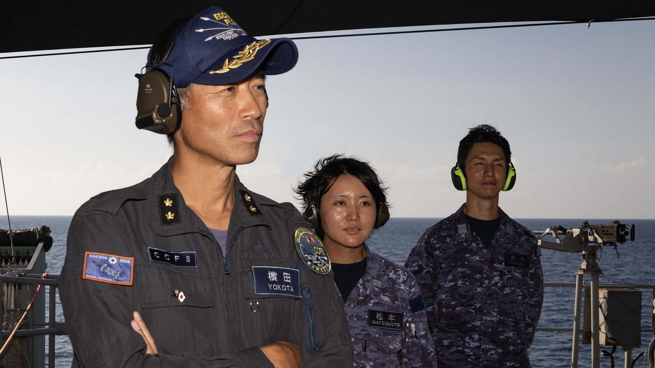 Japan Maritime Self-Defence Force Rear Admiral Kazushi Yokota, Commander, Escort Flotilla 3 and Sub-Lieutenant Ayaka Matsumoto and Commander Kakiuchi Hayato watch a live fire force protection demonstration on board HMAS Warramunga. Picture: Department of Defence.