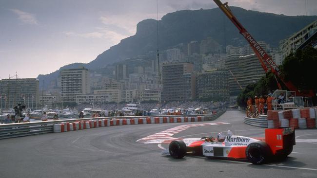 Frenchman Alain Prost takes full advantage of teammate Ayrton Senna clipping a barrier and retiring to take out the 1988 Monaco Grand Prix. Credit: Allsport UK /Allsport