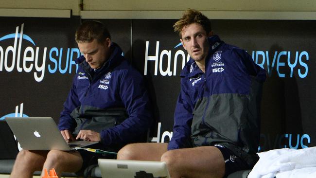 Injured Docker Michael Barlow sits on the bench.