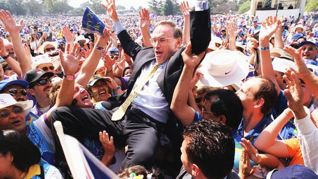 Bob Carr lifted by a crowd during a concert for the Sydney 2000 Olympic Games volunteers in October 2000. It is also the cover picture of his new book.