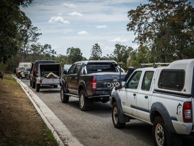 Locals line up at the Bonnick Rd rubbish dump this morning.