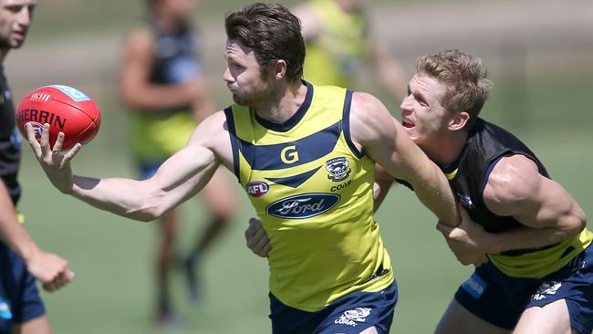 Patrick Dangerfield is tackled by Scott Selwood. Picture: Glenn Ferguson