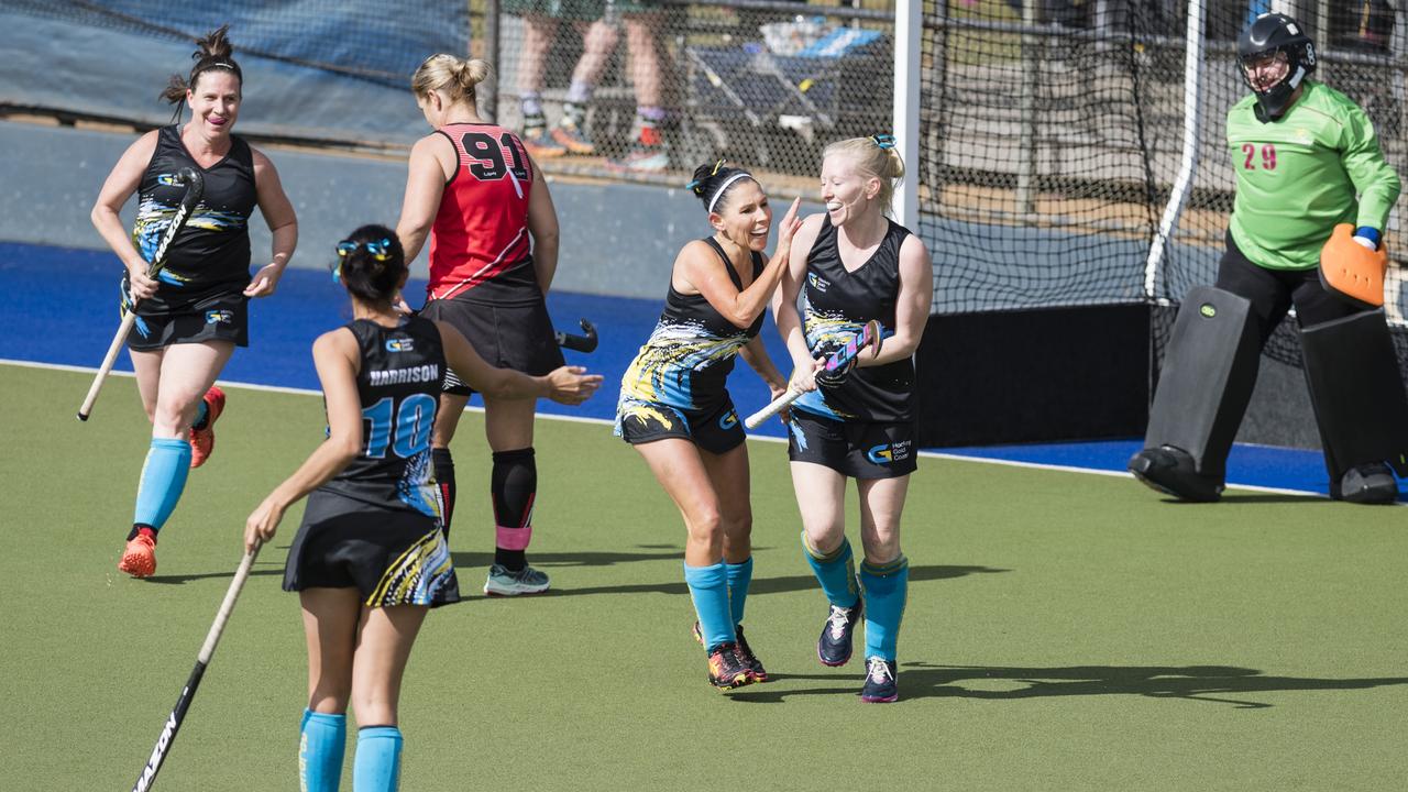 Tamsin Perry (right) celebrates her goal for Gold Coast 1 against Rockhampton 1.