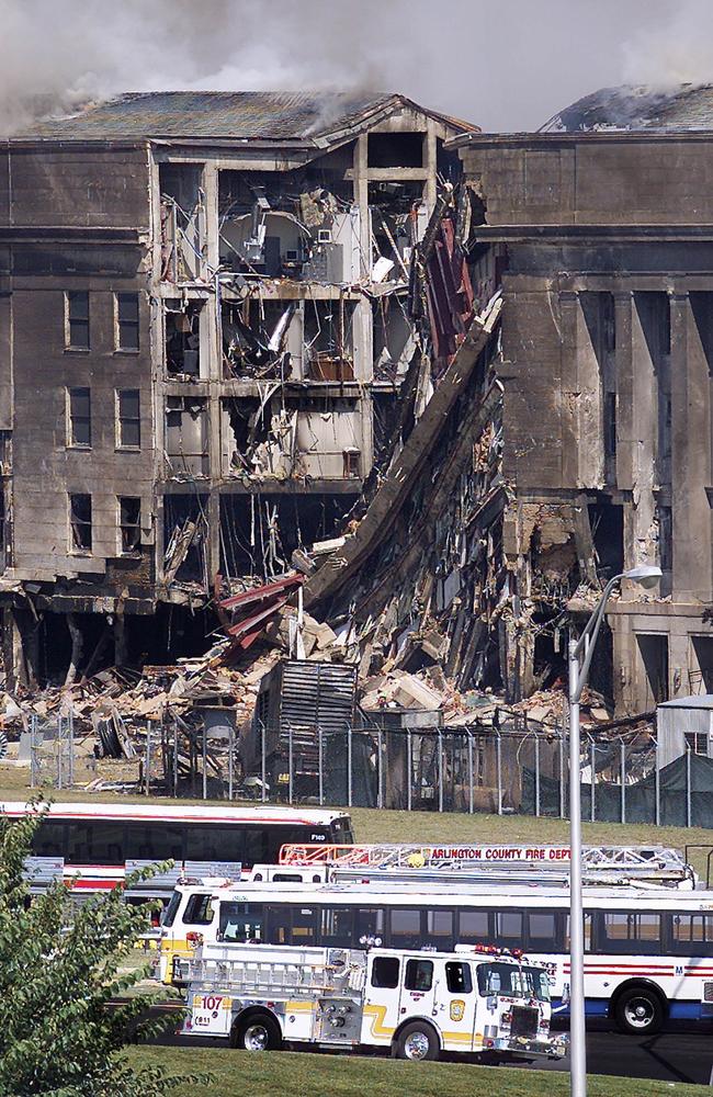 Emergency vehicles stand before the devastated Pentagon hours after the hijacked airplane crashed into the facility. Picture: Stephen Jaffe