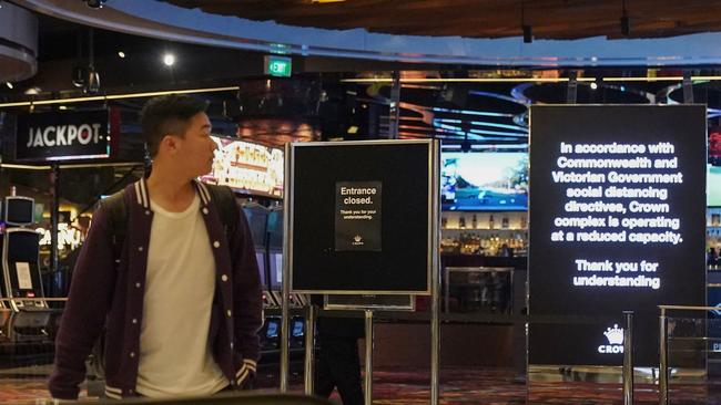 A man look on in front of a closed entrance outside Crown Casino in Melbourne, Monday, March 23, 2020. Crown Casino is among venues that will close for at least three weeks from Monday to curb the spread of the deadly coronavirus. (AAP Image/Scott Barbour) NO ARCHIVING