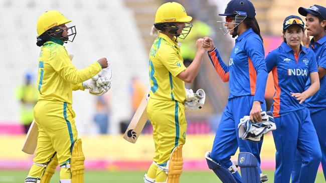 Australia's Alana King (L) and Australia's Ash Gardner fist bump India's Yastika Bhatia