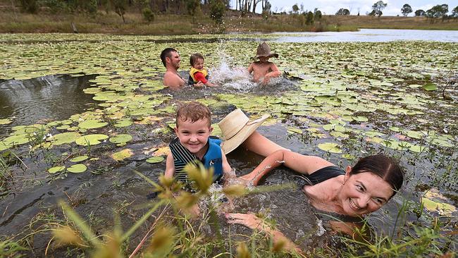 Lahtasha Lewis with Jack, 4, and husband James with Ryan, 8, and Zoe, 5, cool off at Somerset Dam near Kilcoy in Queensland on Sunday. Picture: Lyndon Mechielsen