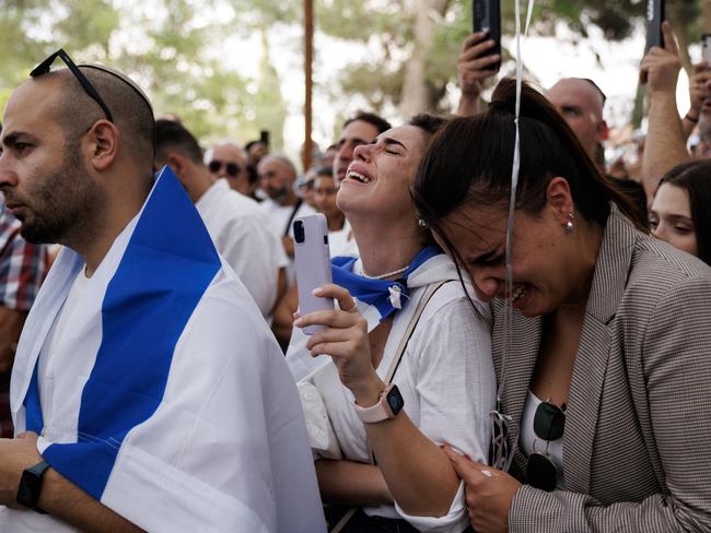 Mourners react as they gather at Mount Herzl cemetery for the funeral of Sgt. Roi Daoui in Jerusalem, Israel. This week, the Israeli government reported the first deaths of soldiers who it said were killed during ground operations in the Gaza Strip. Picture: Getty Images