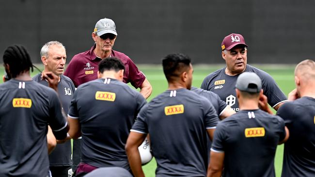 Meninga addresses the players with Bennett looking on closely.