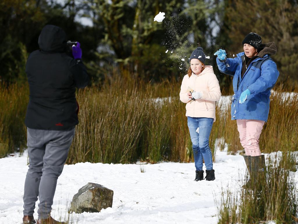 Strong Southerly winds have brought snow to Kunanyi / Mount Wellington over night. Pictured above the Springs is adults and kids in the snow. Picture: MATT THOMPSON