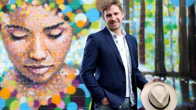 Hugh Sheridan with a mural by artist Jimmy C (James Cochran) in Kent Town. Picture: Calum Robertson