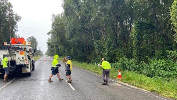 Port Stephens Council workers attending to one of the many potholes the rain has created. On Port Stephens Road. Picture: Supplied.