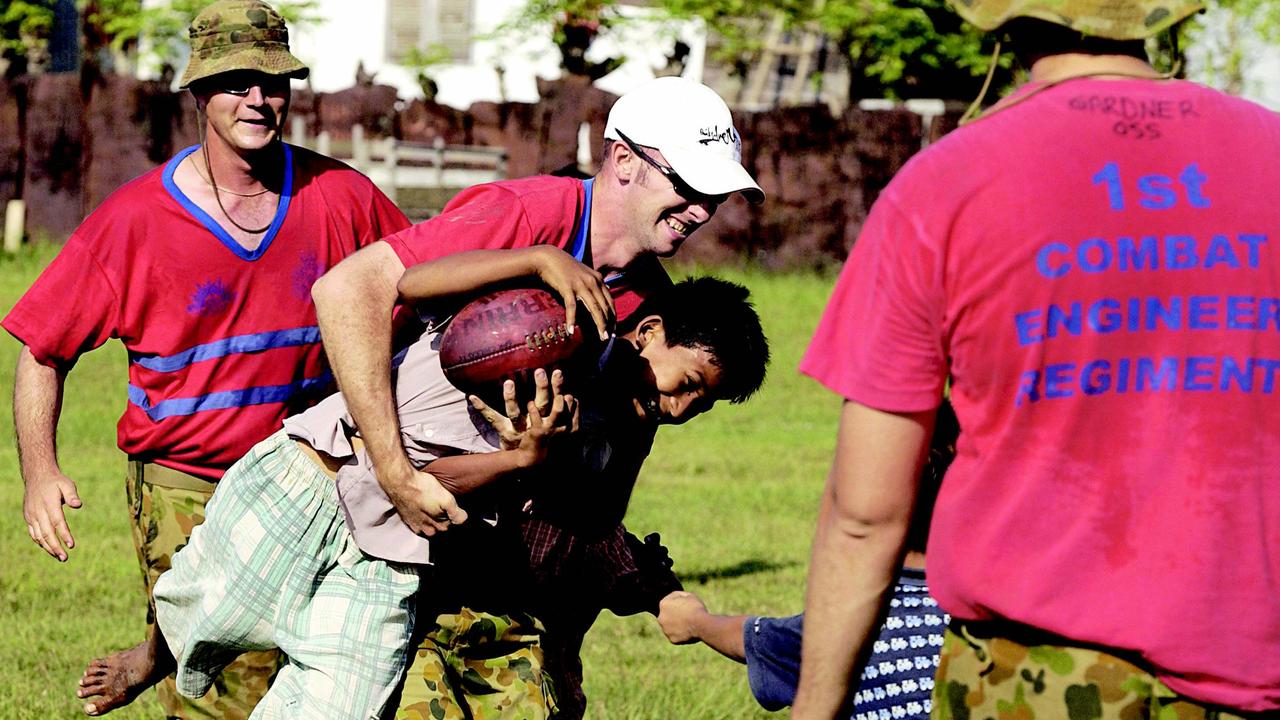 Members of the 1st Combat Engineer Regiment, based in Darwin, teach local children how to play AFL. Picture: Department of Defence