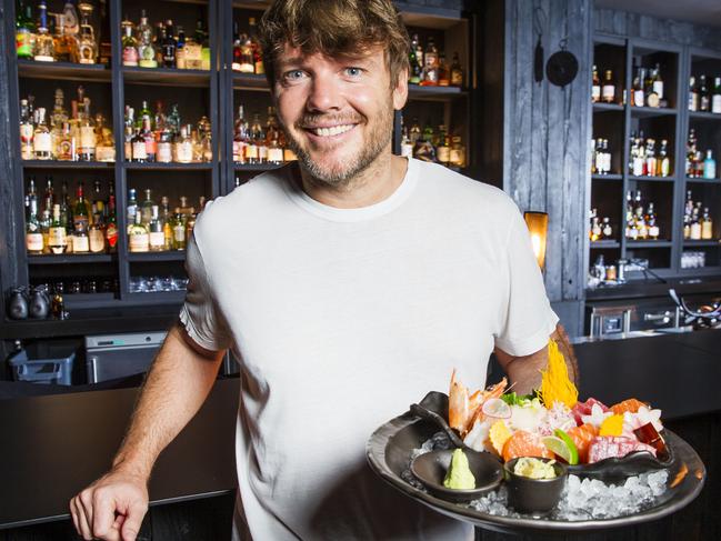 Co Owner Tyron Simon holds a plate of Sashimi at Honto in Fortitude Valley who have taken out the Delicious 100 People's Choice Award. Photo Lachie Millard