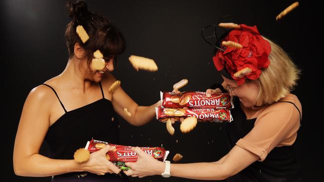                         <s1>Darwin’s Isabella Marovich and Kate Hulls fight over their favourite biscuits. </s1>Picture: Keri Megelus