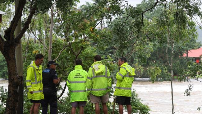 Emergency servics check out Aplins Weir is itÃ&#149;s overflowing. Townsville residents endure another day of heavy rain and threats of catastrophic flooding. Pics Adam Head