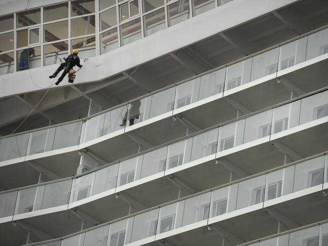 A worker paints the ship.