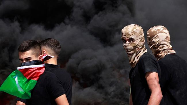 Palestinians burn tyres amid clashes with Israeli security forces during the funeral of 19-year-old Labib Damidi in the occupied West Bank town of Huwara on October 6, 2023. Palestinian Damidi was killed early on October 6 during clashes with Israeli soldiers and settlers in the town. Picture: Jaafar ASHTIYEH / AFP