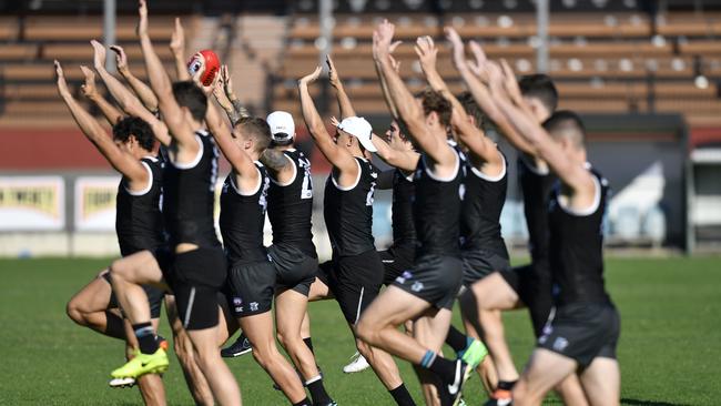 Port Adelaide players will have to work through 13 consecutive games to keep their hands up for AFL finals action in September. This is the longest marathon run among all the top-eight contenders. Picture: Kelly Barnes