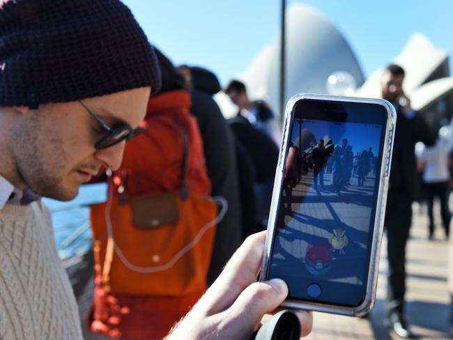 Dozens of people gather to play in front of the Opera House Picture: AFP PHOTO/William West