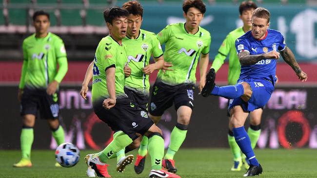 Socceroos and Suwon Bluewings striker Adam Taggart, right, tries his luck against Jeonbuk during the opening game of South Korea’s K League season in Jeonju on Friday night. Picture: AFP