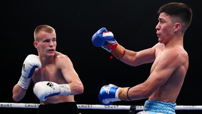 Liam Wilson of Australia knocks down Mauro Perouene of Argentina in the IBF Super Featherweight World Youth Title fight. Picture: Chris Hyde/Getty Images