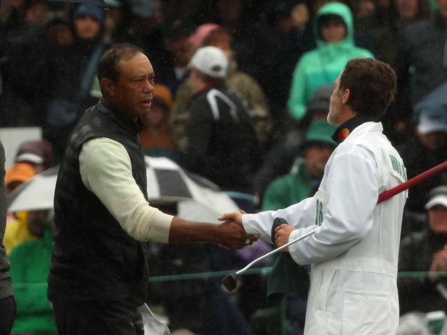 AUGUSTA, GEORGIA - APRIL 08: Tiger Woods of the United States shakes hands with Viktor Hovland of Norway caddie Shay Knight on the 18th green during the continuation of the weather delayed second round of the 2023 Masters Tournament at Augusta National Golf Club on April 08, 2023 in Augusta, Georgia. (Photo by Patrick Smith/Getty Images)