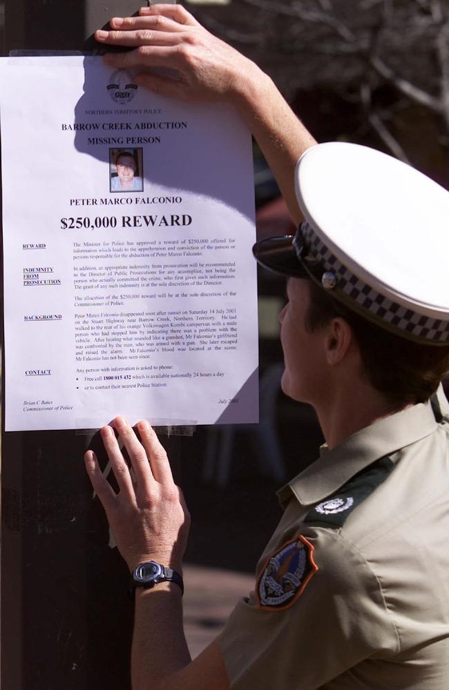 Snr Sgt Colleen Gwynne places the a missing person poster offering $250,000 reward for the whereabouts of Peter Falconio.