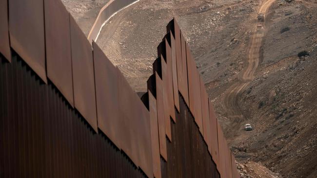 Construction crews work on a new section of the US-Mexico border fencing in eastern Tijuana. Picture: AFP