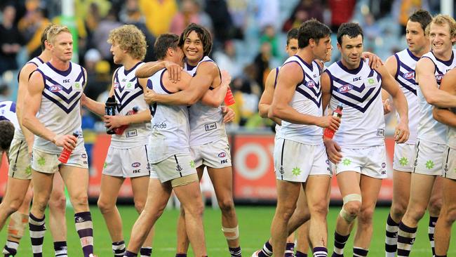 Fremantle celebrate their win in the wet in 2012. Picture: AAP Image/David Crosling