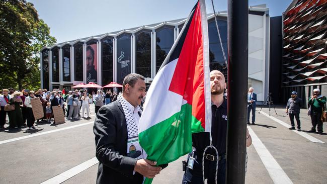 Labor councillor Karl Saleh and a security guard raise the Palestinian flag at Paul Keating Park in Bankstown last year. Picture: Julian Andrews