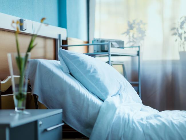 side view of empty hospital bed in clinic chamber