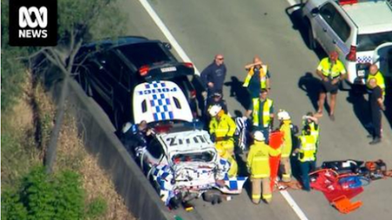 Police car destroyed after ute crashes into it on M1 at Helensvale ...