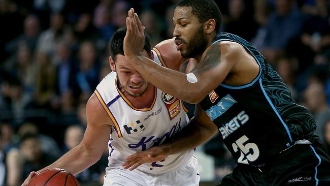 Jason Cadee of the Kings (left) is challenged by Devonte (DJ) Newbill of the Breakers on Thursday night.