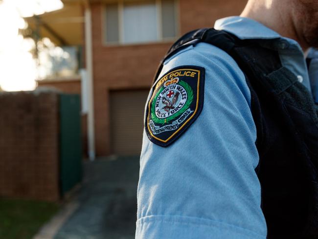 DAILY TELEGRAPH. Embed with police on Operation Amarok regional domestic violence response on the NSW Mid North Coast. In this picture, police conduct an AVO compliance check at an address in Kempsey. GENERIC police badge patch. Wednesday 15/05/2024. Picture by Max Mason-Hubers Police knock on the door of a Kempsey home in order to do an compliance check. No one is home and we leave.