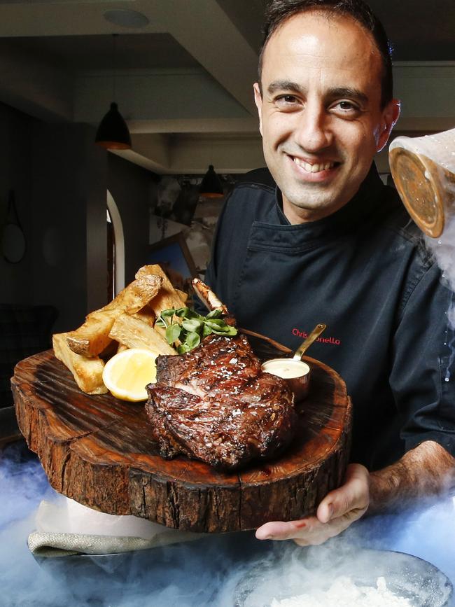 MPD Steak Kitchen executive chef Chris Bonello with a signature Tomahawk steak. Picture: David Caird