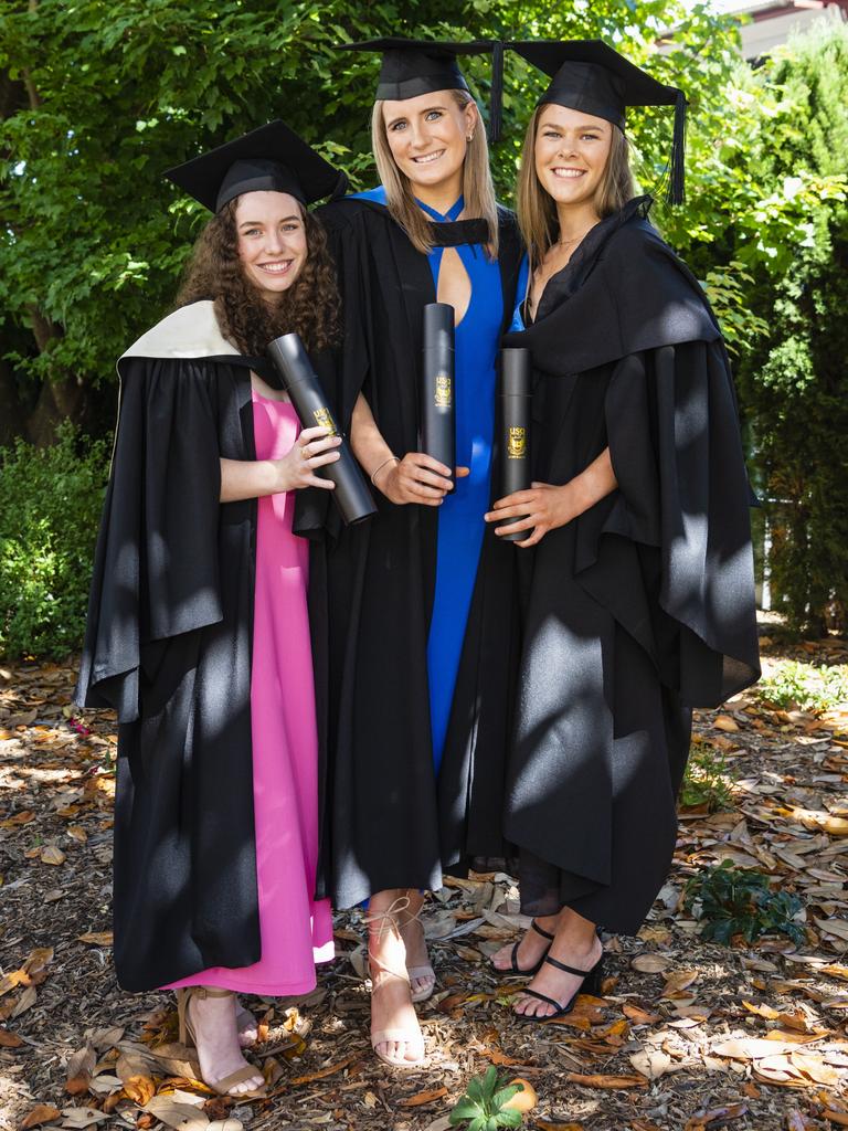 Good friends (from left) Lily Ryan (Bachelor of Communication and Media), Paris Pola (Bachelor of Nursing) and Bec Ryan (Bachelor of Nursing) celebrate graduating together at the UniSQ graduation ceremony at Empire Theatres, Wednesday, December 14, 2022.